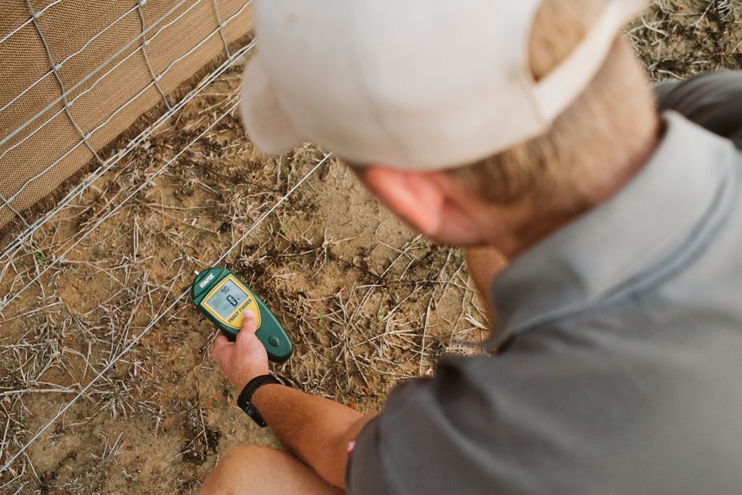 A volunteer checks the fence