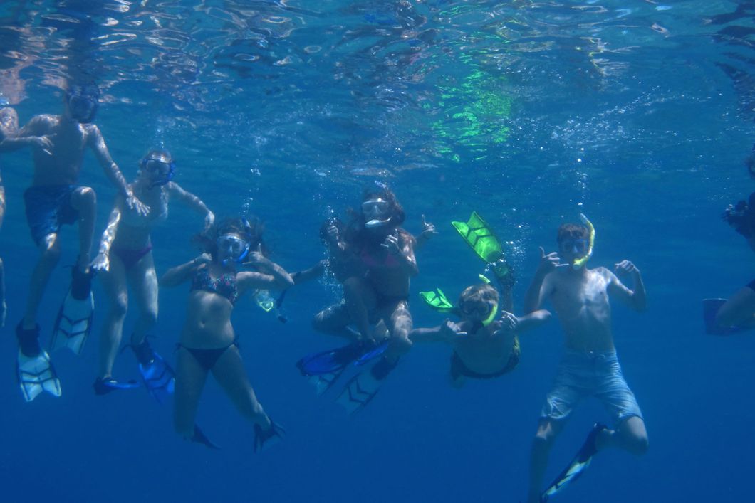 Underwater shot of a group of conservation volunteers diving off the Hawaiian coast