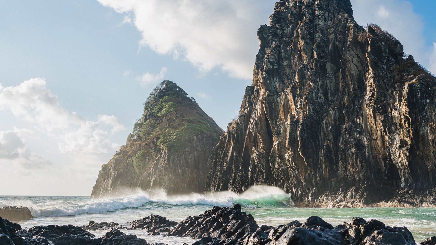 Waves crash on the rocks of Fernando De Noronha