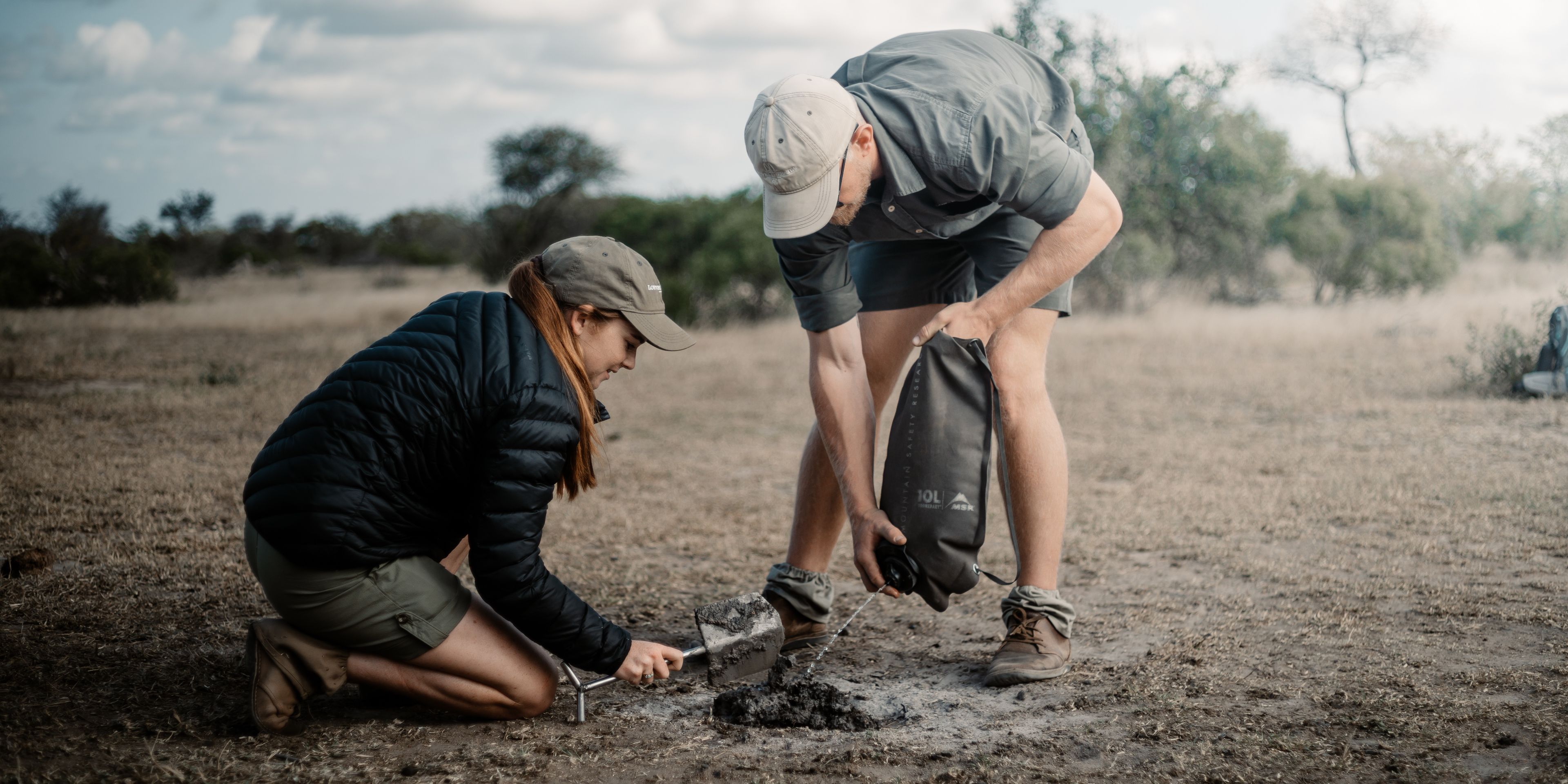 Two people looking at firepit