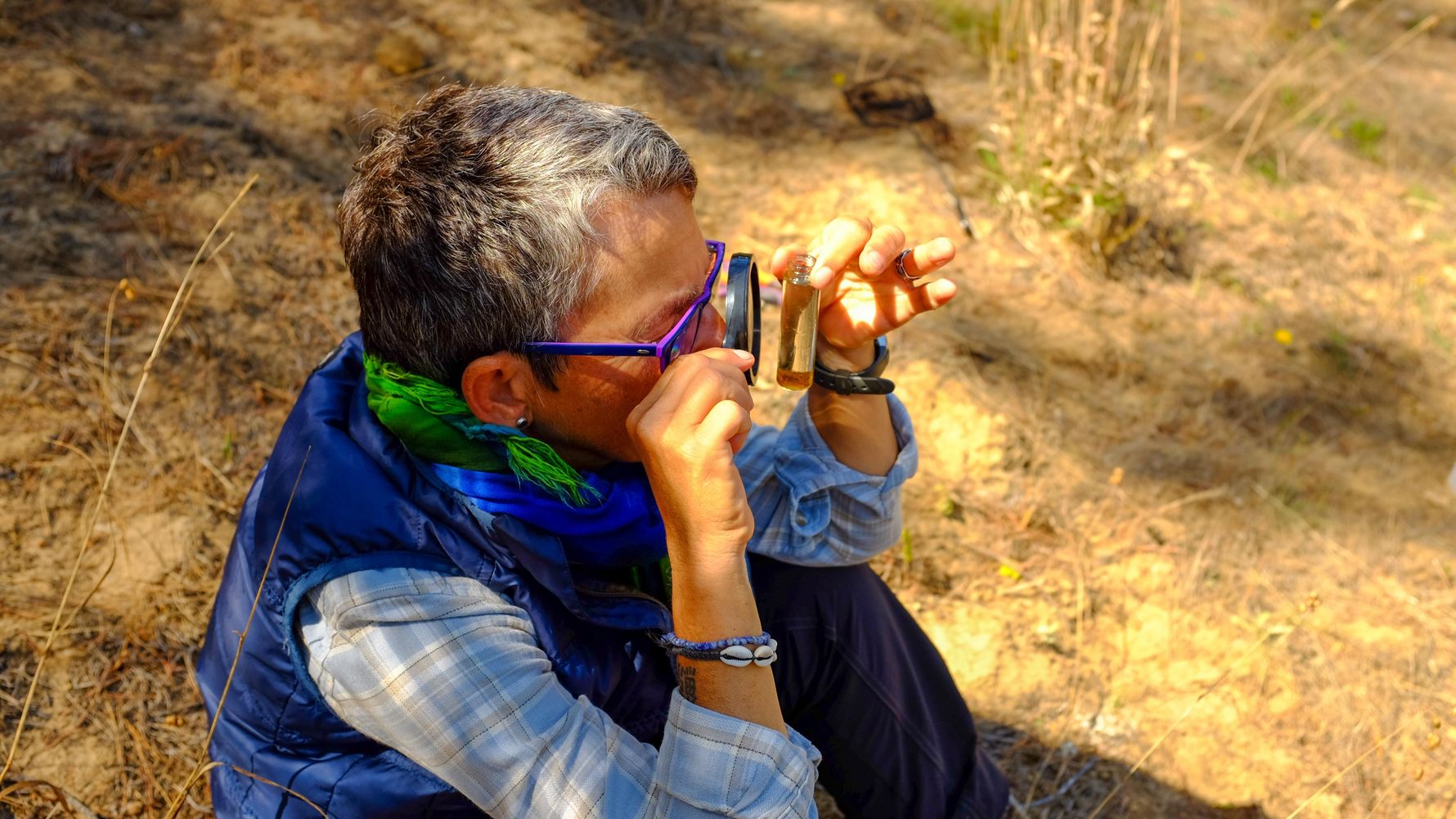 Woman looking at a leaf through a microscope