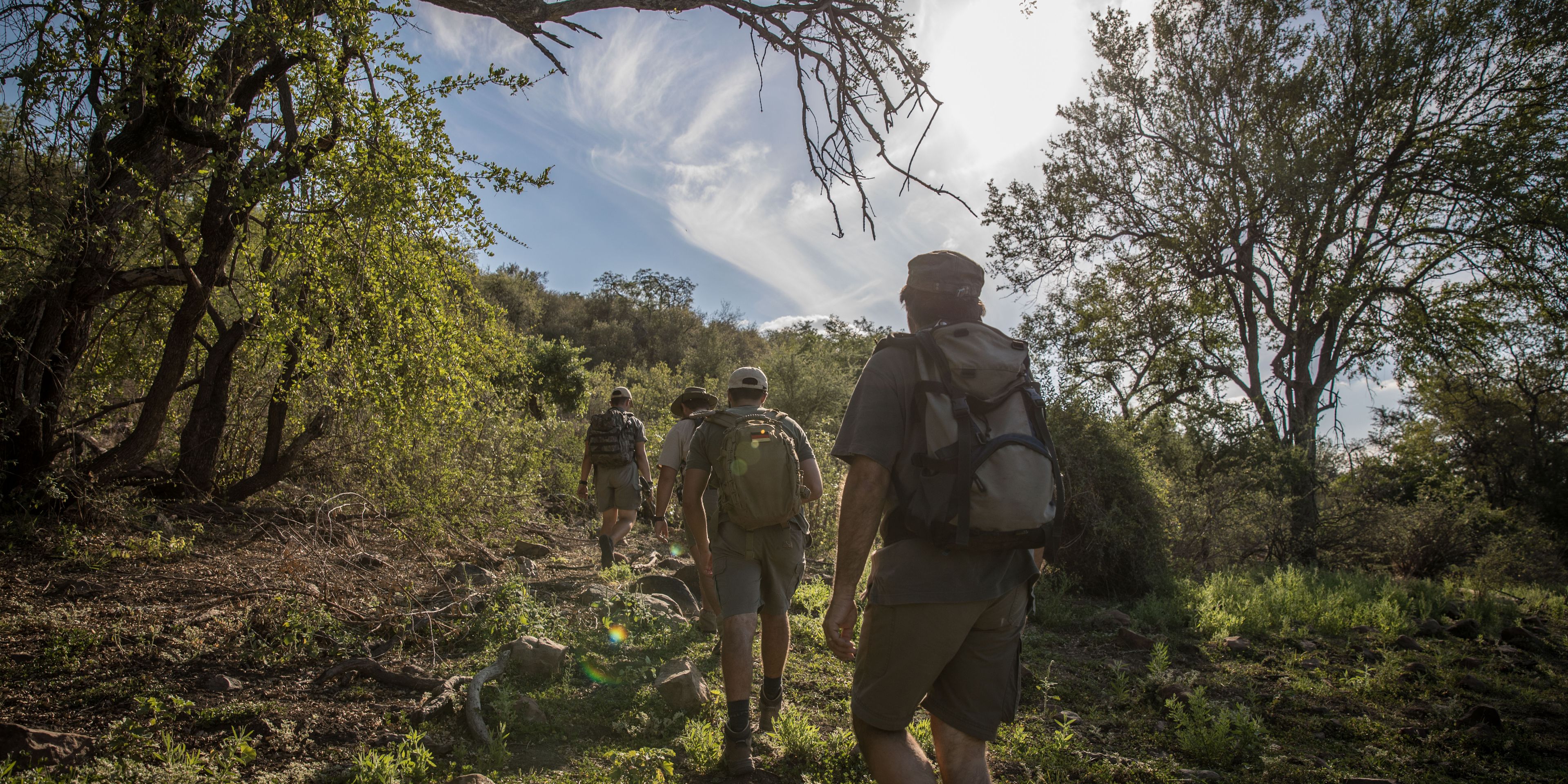 Die Studenten des Natur- und Rangerkurses wandern als Teil einer Pirschwanderung durch den afrikanischen Busch