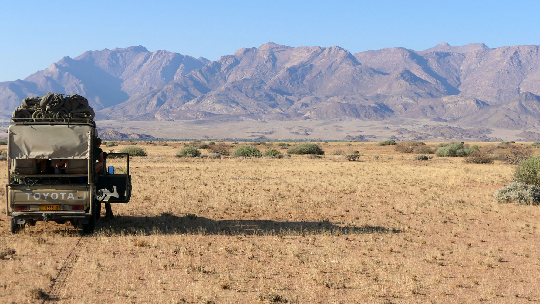 Elephant conservation in Africa: An open game drive vehicle which is tracking elephants in Namibia's Damarland