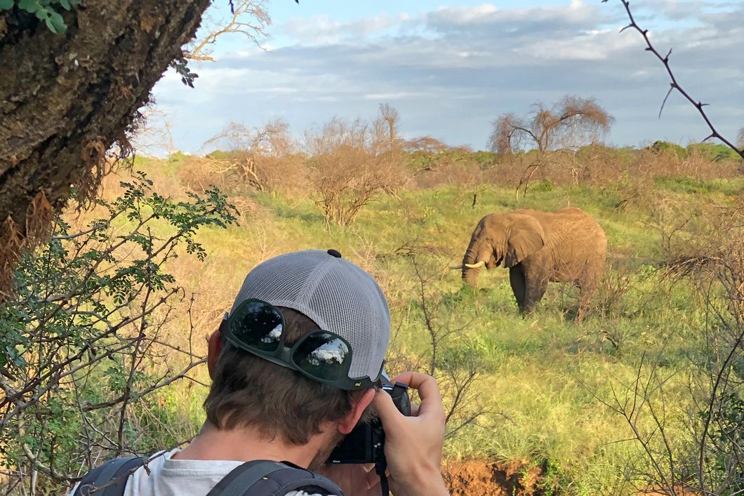 Course student of the game ranger short course taking a picture of an elephant in Southern Africa