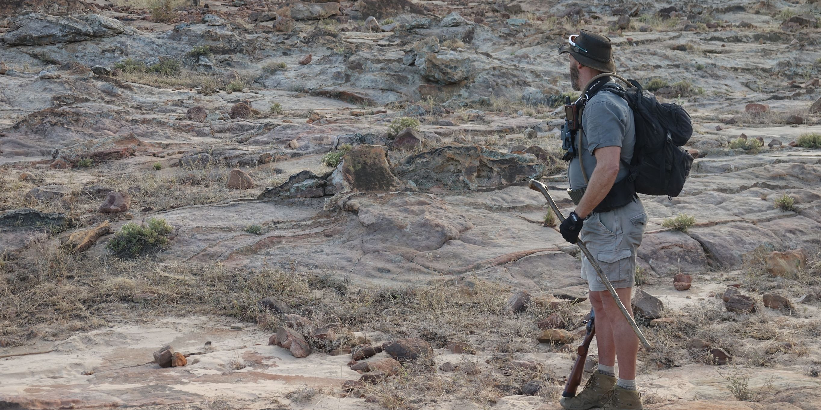 Man standing in a dry riverbed