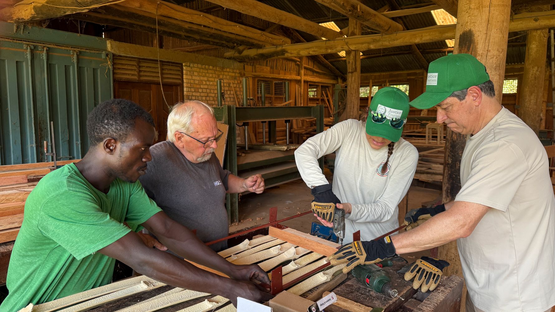 Four people in the workshop room are working with bamboo