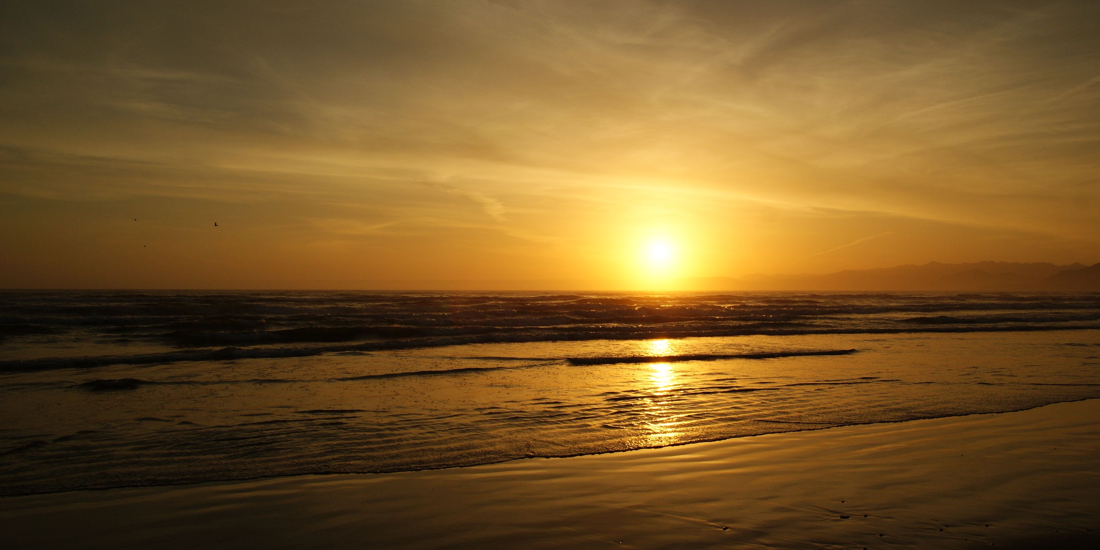The breaking waves of the Pacific Ocean on the US West Coast at sunset