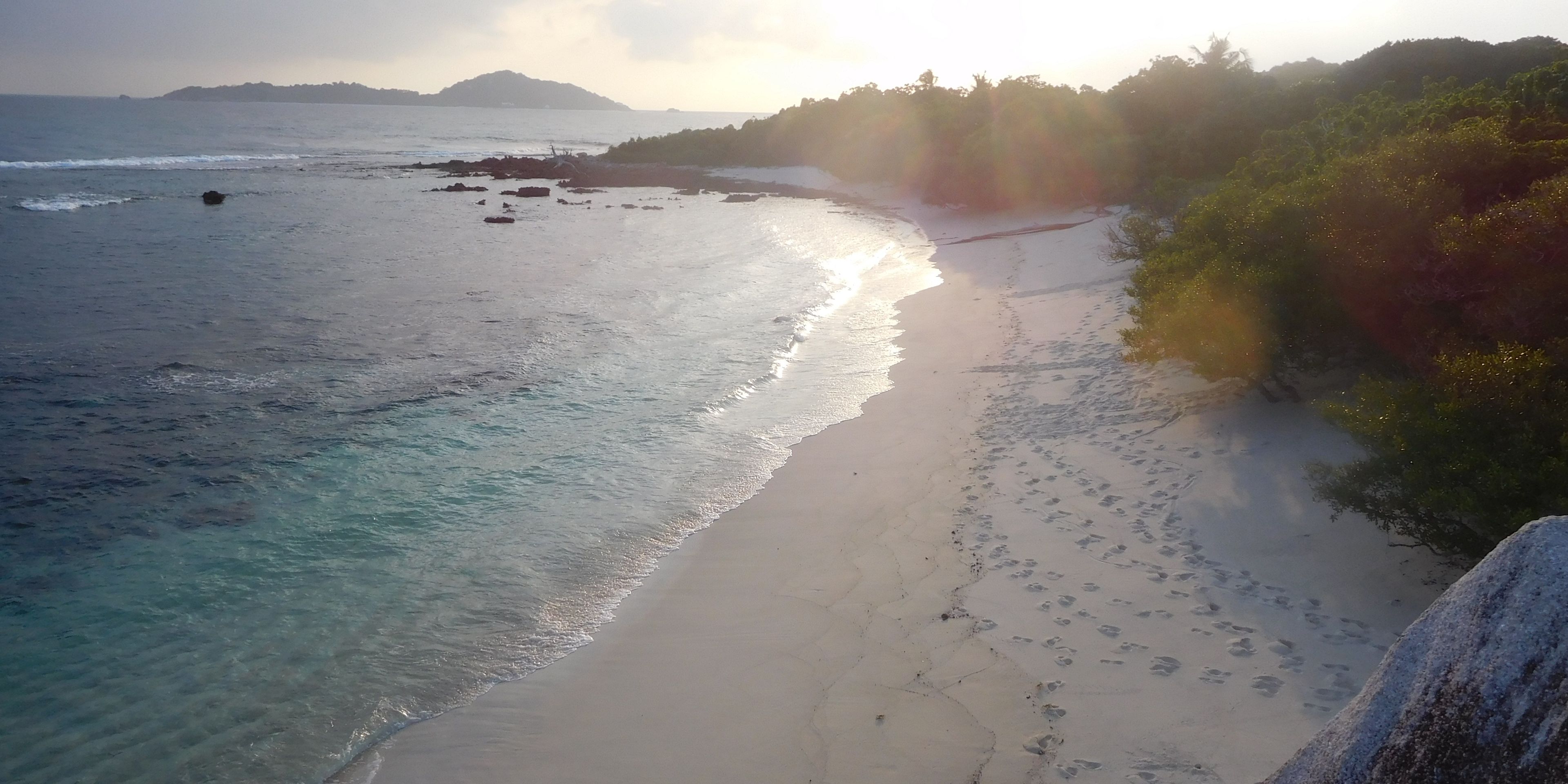 Cousin Island beach is covered in soft colours by the evening sun