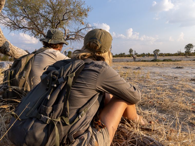 Mann und junge Frau sitzen im Okavango Delta
