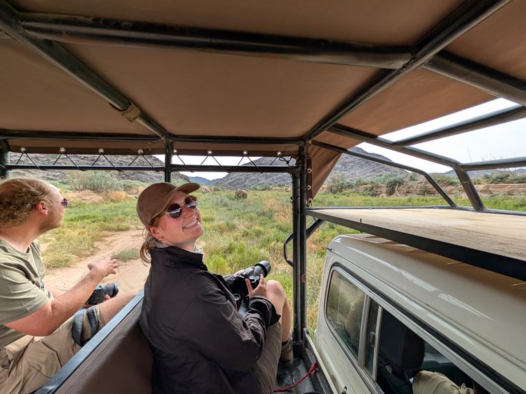 Woman with camera in game vehicle