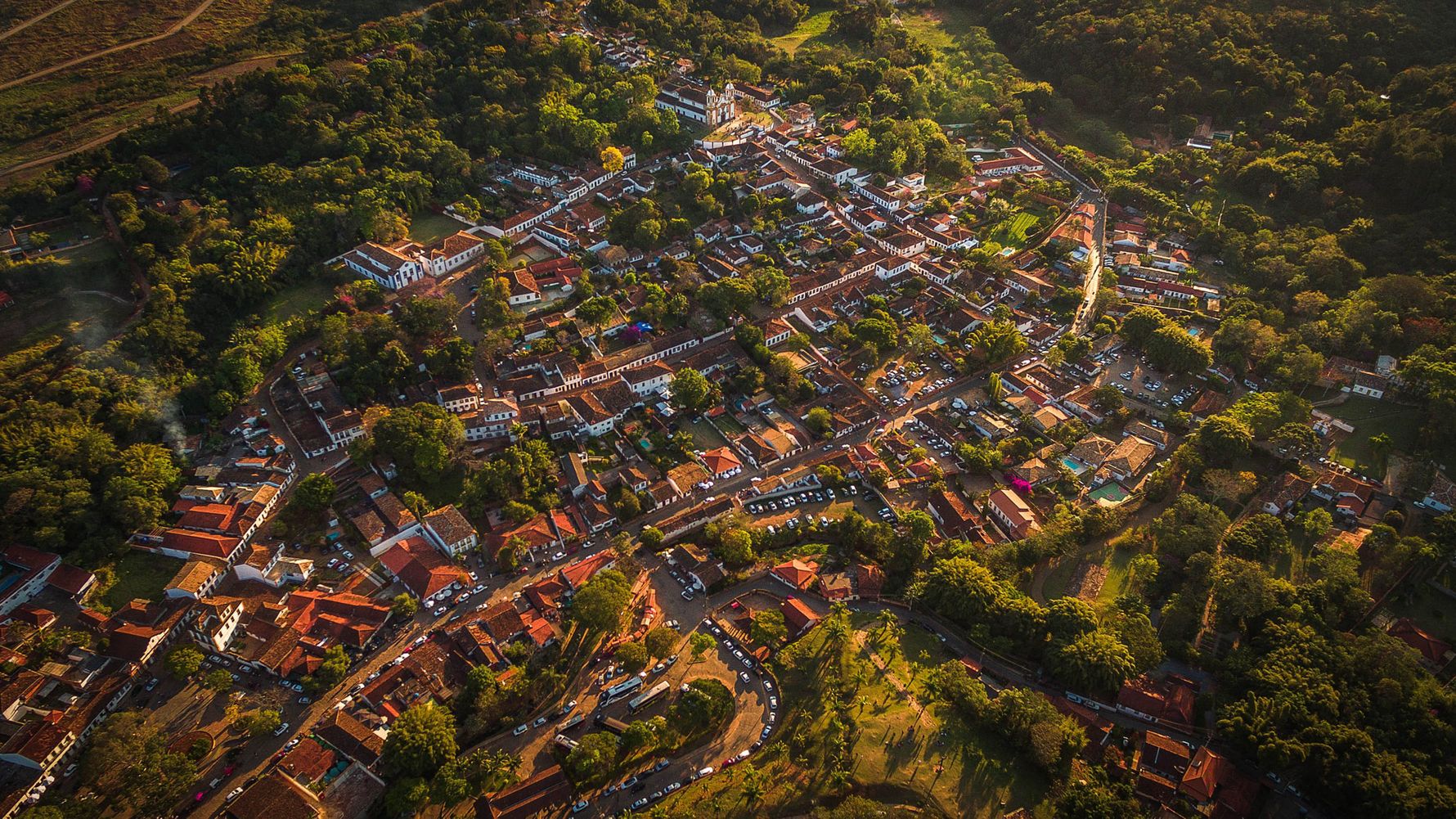 This aerial view of Tradentes shows a settlement with white houses and their red roofs