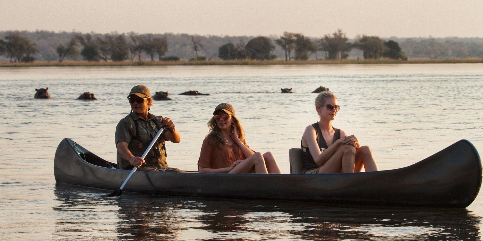 Waehrend einer Bootsfahrt auf dem Fluss koennen viel Hippos beobachtet werden