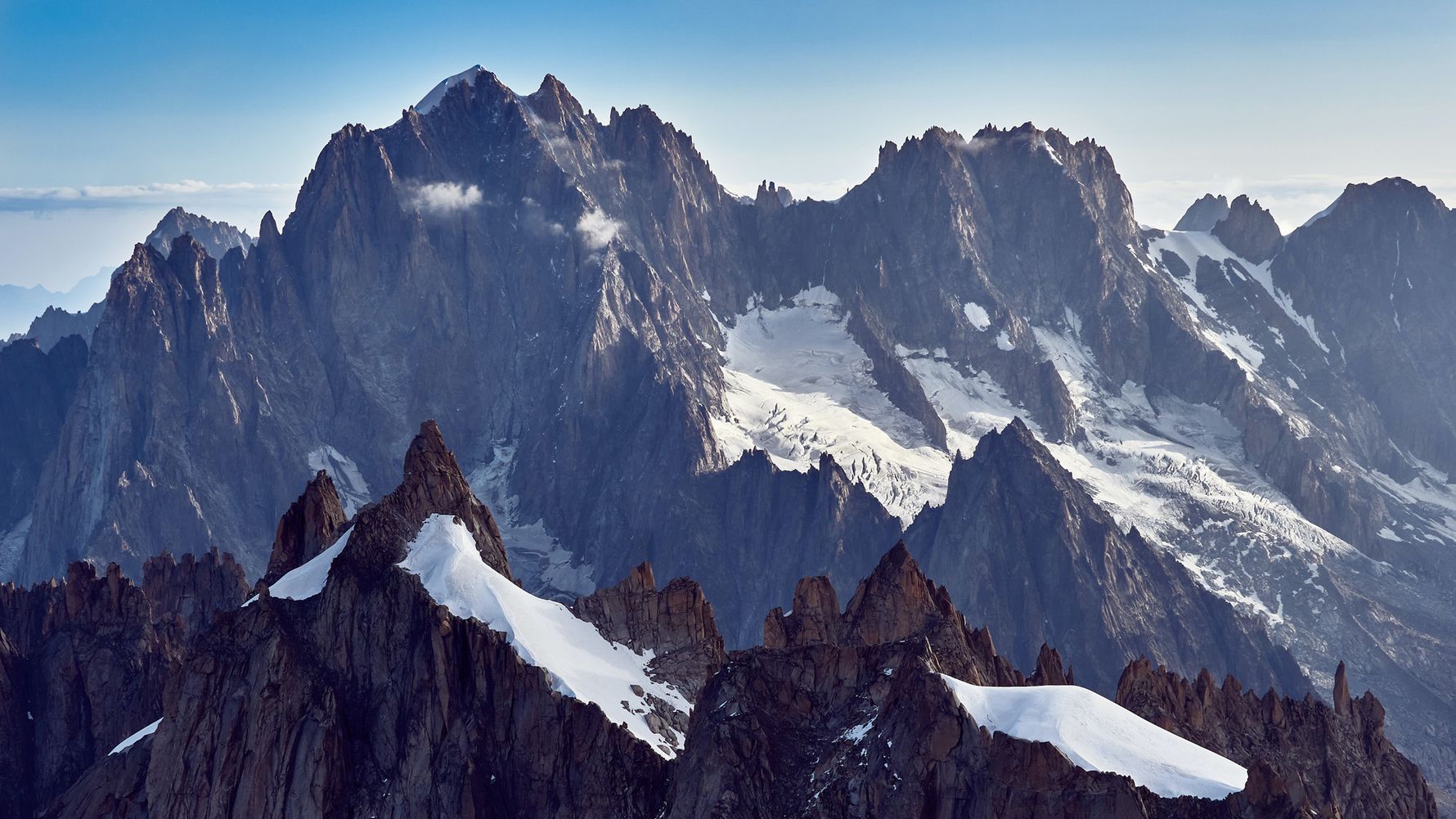 Rocks of Mont Blanc from the French Alps with some snow against a blue sky